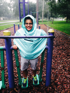 Playing at the park wearing Roo Rain Gear rainwear made from RPET